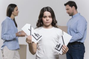 portrait-sad-girl-with-parents-arguing